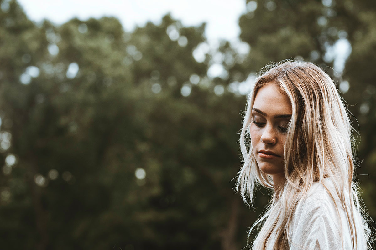 A woman outdoors thinking about abortion